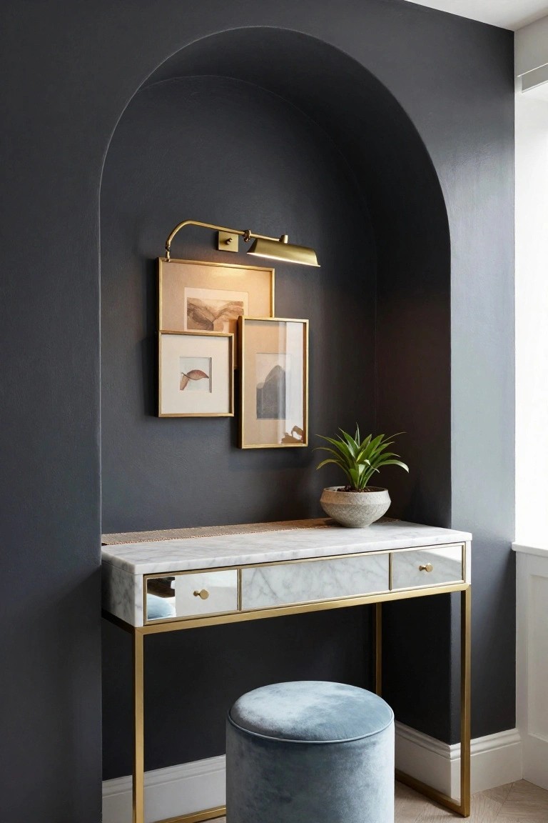 Modern vanity desk with marble top, gold frame, blue stool, and arched wall niche.