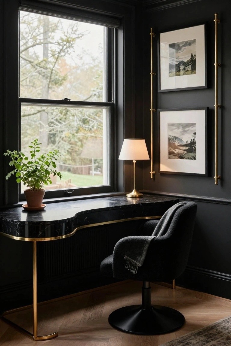 Curved black marble desk with brass trim and legs in a dark-walled office corner, paired with a black swivel chair, table lamp, potted plant on the desk, framed artwork on brass wall brackets, and a large window showing trees outside.