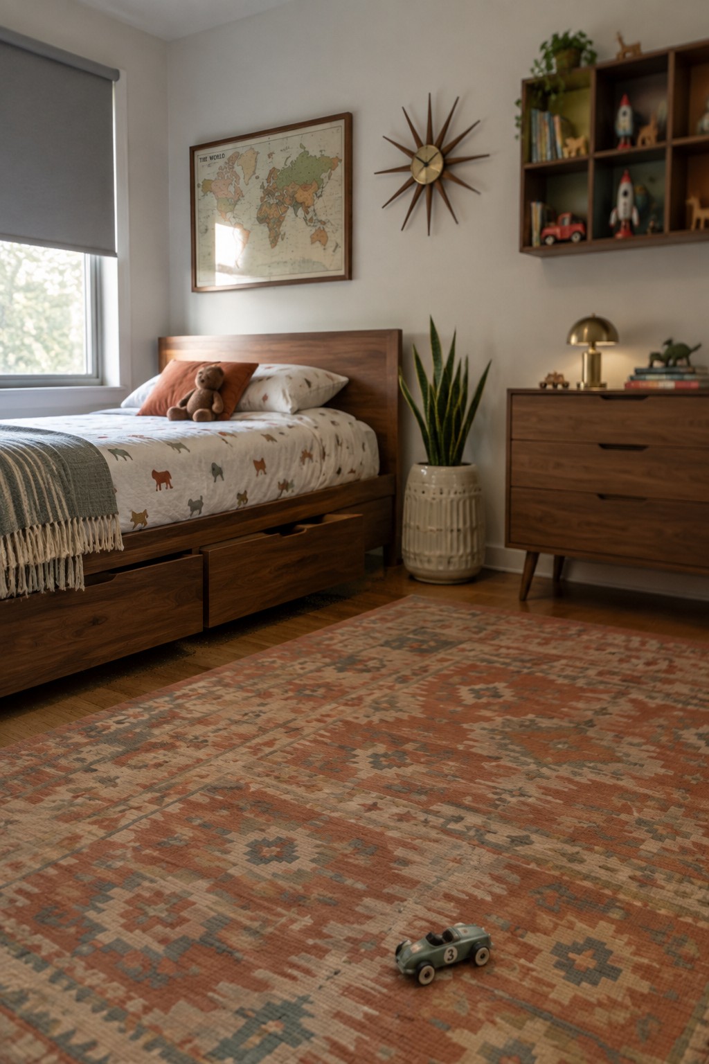 A child's bedroom with a wooden bed featuring under-bed storage drawers, animal-patterned bedding, a world map on the wall, and a large patterned rug on the hardwood floor.