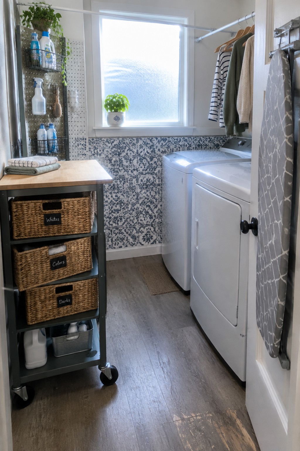 Organized laundry room with sorting cart, washer, dryer, pegboard, and window view.